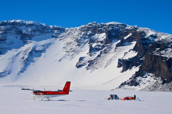 ALE base camp in Mount Sidley's caldera. The sheer wall of the Weiss Amphitheater rises up behind camp.